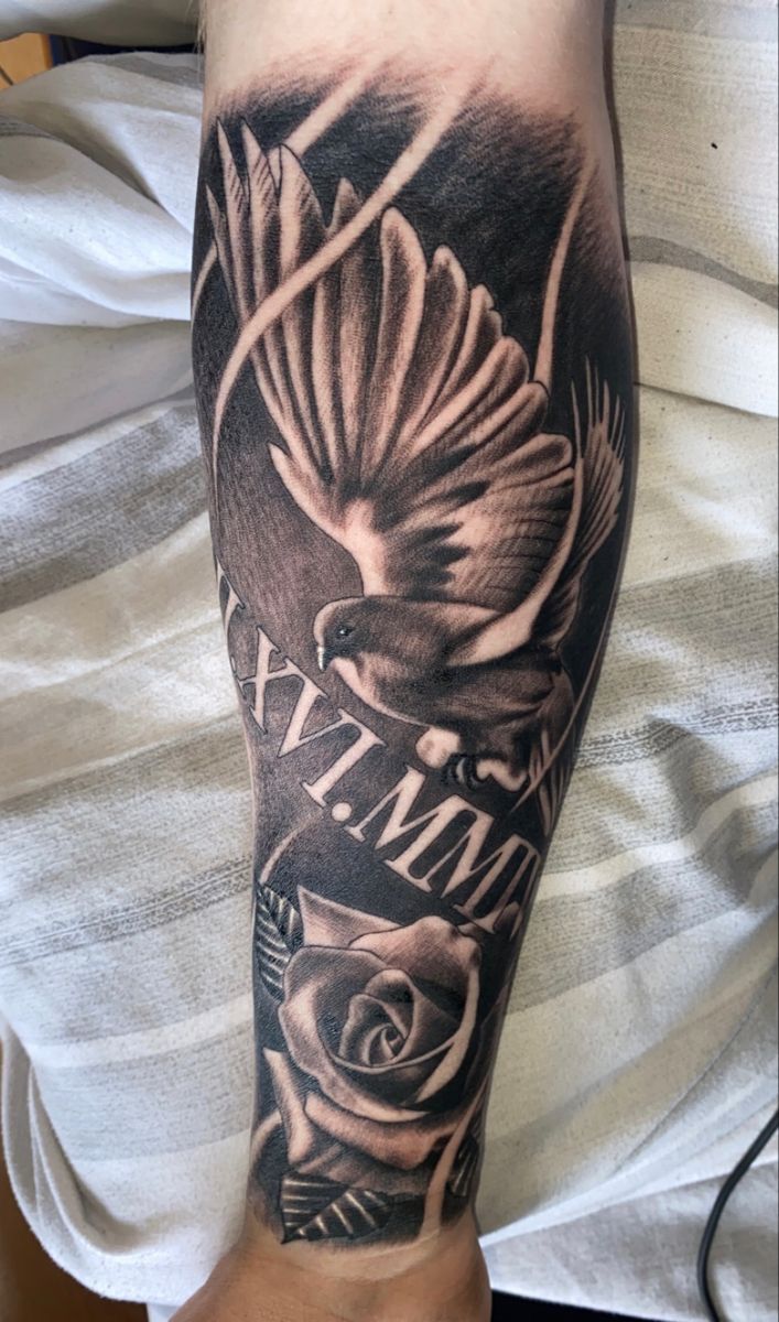 a man's arm with a black and white tattoo on it