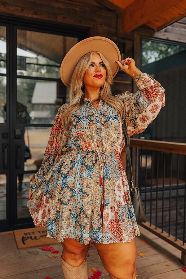 - This flowy dress is as beautiful as a fall sunset! - Airy chiffon material with an abstract print featuring yellows, blues, and coral hues - A v-cut neckline - A button-up bodice - A cinched drawstring waistline with accent tassels - A built-in skirt lining - A flowy yet flattering silhouette that ends in a mini dress length hemline Fall Bridal Shower Outfit For Guest, Fall Wedding Outfit Guest, Bridal Shower Guest Outfit, Shower Outfit For Guest, Western Dress With Boots, Fall Sunset, Mini Dres, Skirt Lining, Bridal Shower Outfit