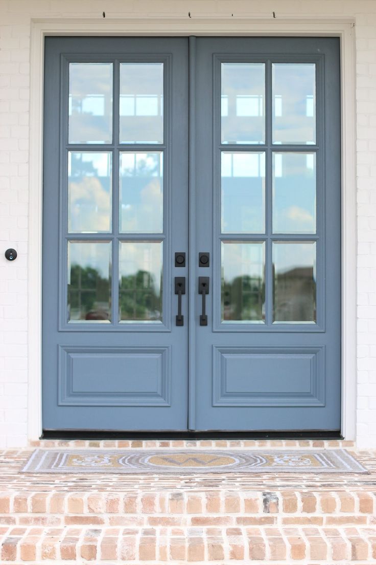 two blue double doors with brick steps leading up to them