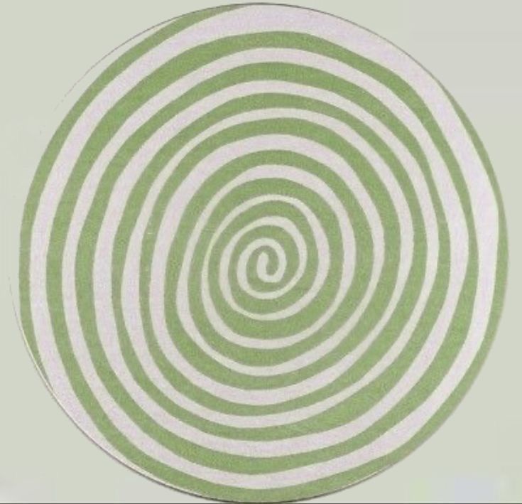 a green and white circular design on a wall