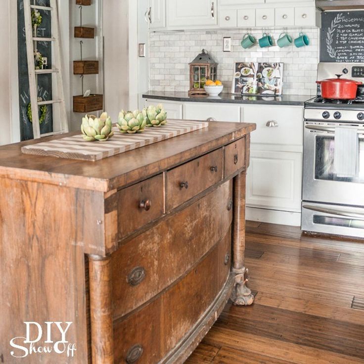 a kitchen with an island in the middle and lots of cupboards on the other side