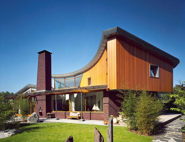 a house with a curved roof and two chimneys