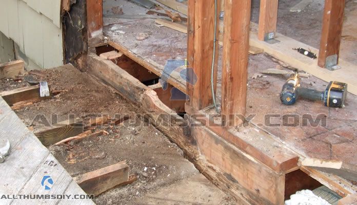 the inside of a house under construction with wood framing and tools on the ground next to it