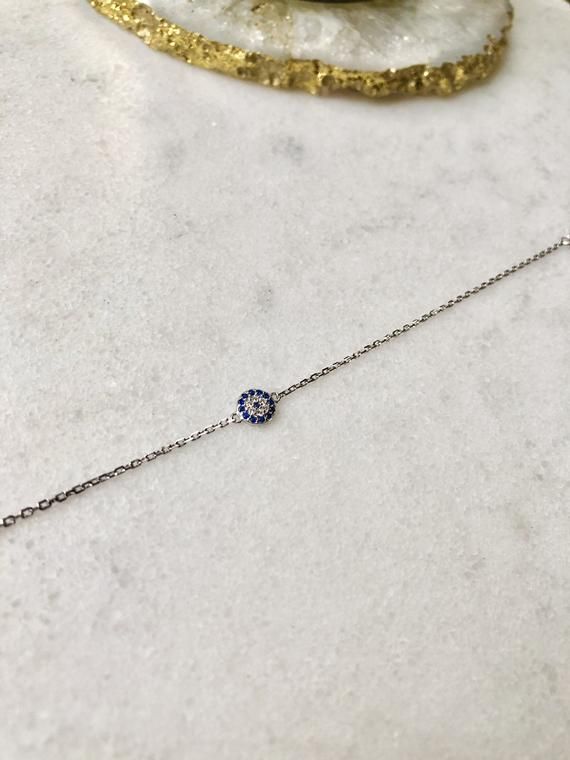 Beautifully light Sterling Silver chain bracelet with Cubic Zirconia Evil Eye charm; adjustable in length up to 7.5 inches This bracelet is perfect for gifting with our matching necklace & stud earrings also available:Necklace:https://www.etsy.com/uk/listing/727886349/sterling-silver-evil-eye-necklace?ga_search_query=Evil%2Beye&ref=shop_items_search_5Earrings:https://www.etsy.com/uk/listing/826524760/sterling-silver-evil-eye-earrings?ga_search_query=Evil%2Beye&ref=shop_items_search_6 Adjustable Delicate Chain Jewelry With Cubic Zirconia, Adjustable Delicate Cubic Zirconia Jewelry, Gift Jewelry With Adjustable Length And Cubic Zirconia, Adjustable Delicate Cubic Zirconia Chain Jewelry, Adjustable Length Sterling Silver Jewelry, Resizable Cubic Zirconia Jewelry For Gifts, Dainty Adjustable Silver Chain Jewelry, Silver Chain Bracelets As Gift, Round Silver Chain Bracelets As Gifts