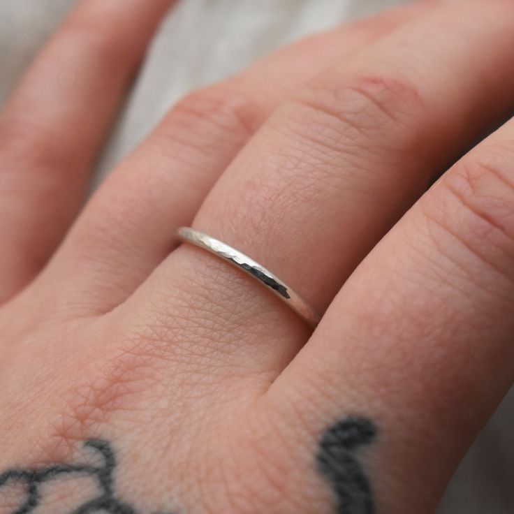 This adjustable hammered sterling silver ring is designed for both men and women who enjoy wearing minimalist style jewelry. This ring is super lightweight and comfortable, making it the perfect everyday wear with any outfit. Stack it or mix and match with other metals. Puffy fingers are no match for this ring! Completely handcrafted by me (Kahlia) in Washington State out of my school bus work studio. Handmade with raw 925 sterling silver wire, this ring is hammered to perfection and polished to Hammered Sterling Silver Midi Rings, Everyday Minimalist Hammered Midi Rings, Everyday Hammered Sterling Silver Stackable Rings, Everyday Adjustable Hammered Stackable Rings, Minimalist Hammered Ring With Open Band, Minimalist Hammered Sterling Silver Midi Rings, Minimalist Hammered Open Band Ring, Minimalist Hammered Round Band Ring, Minimalist Adjustable Hammered Midi Rings