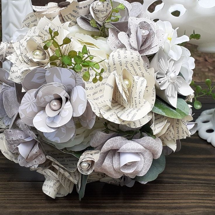 a bouquet of paper flowers sitting on top of a wooden table