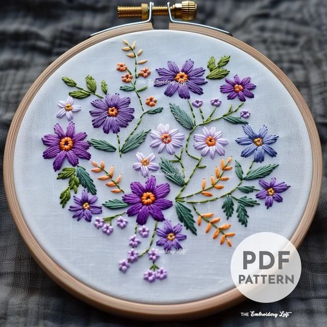 an embroidery pattern with purple flowers and green leaves