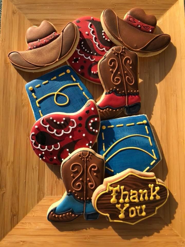 decorated cookies in the shape of cowboy boots and boots with thank you written on them