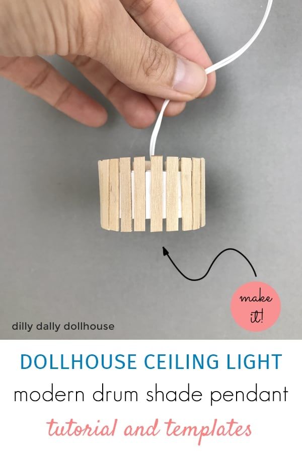 the dollhouse ceiling light is made out of wooden sticks and attached to a string