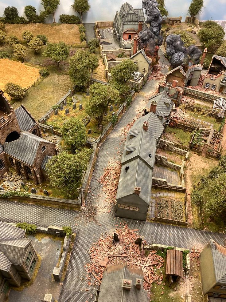 an aerial view of a small town with lots of trees and buildings on the ground