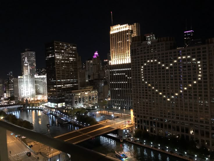 the city skyline is lit up at night