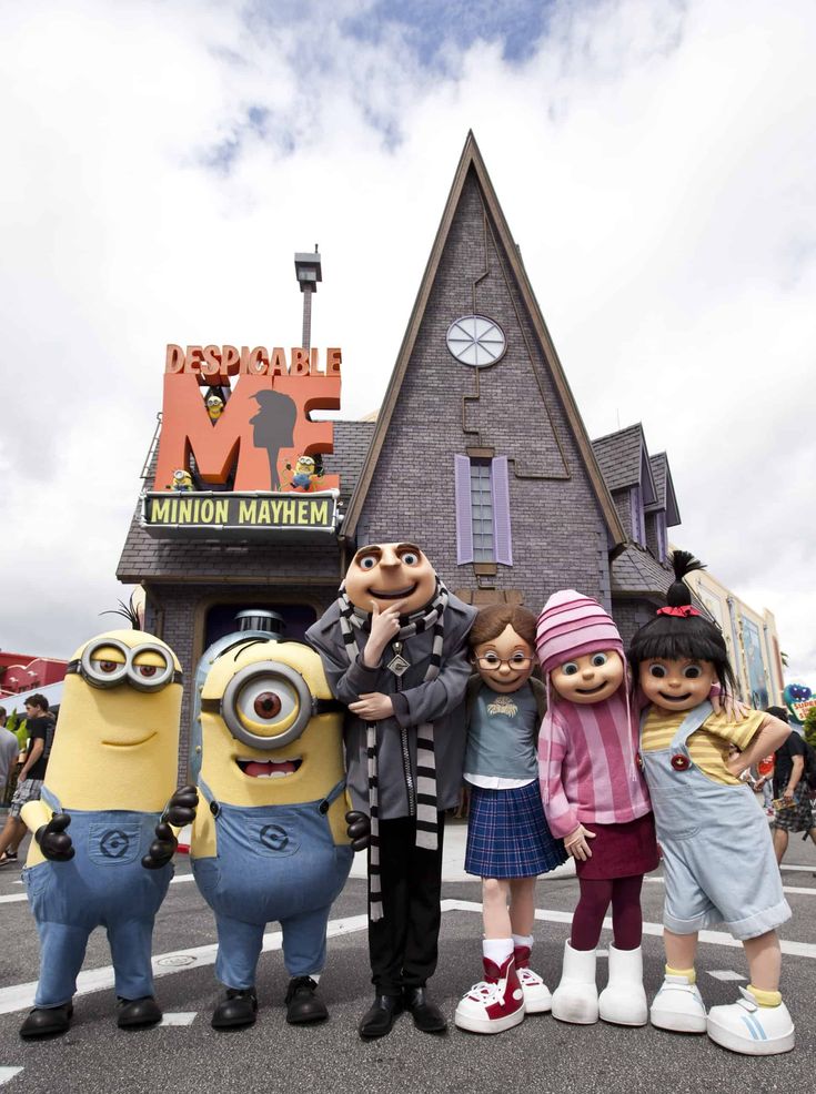 some very cute minion characters in front of a building