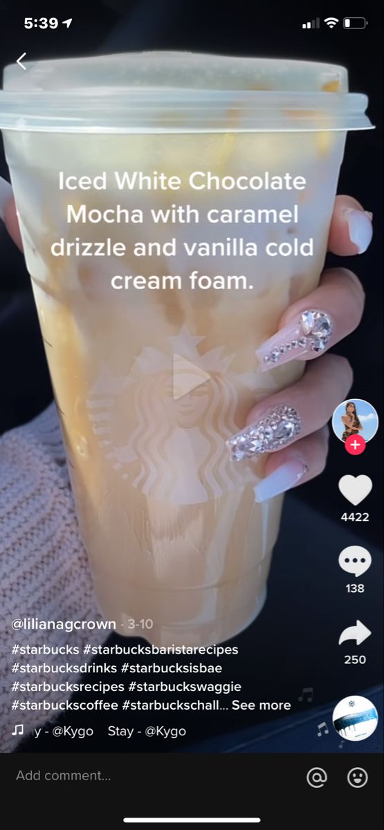 the starbucks drink is being served in a cup with white frosting and silver decorations on it