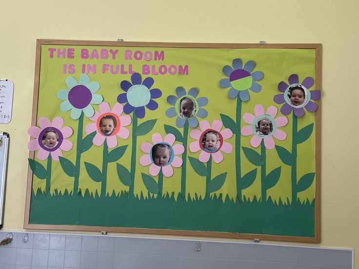 a bulletin board with pictures of babies in flowers