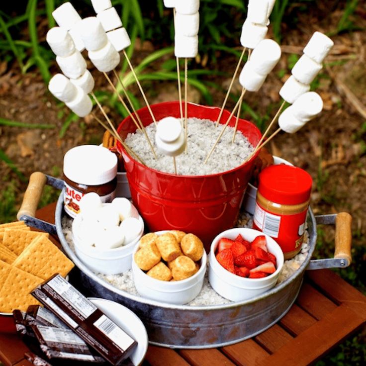 a bucket filled with marshmallows and other snacks