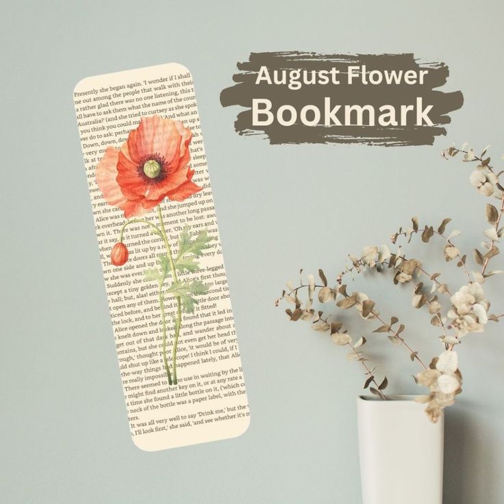 a bookmark with an image of a flower on it next to a white vase