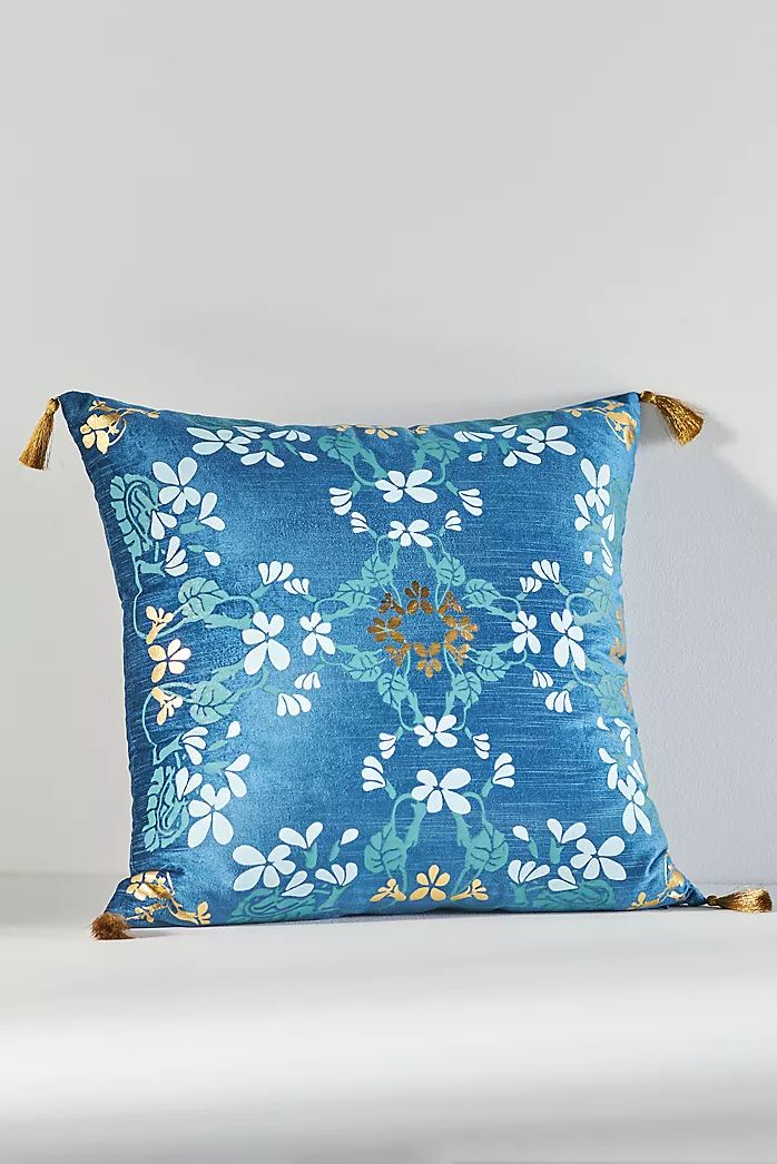 a blue pillow with white flowers on it