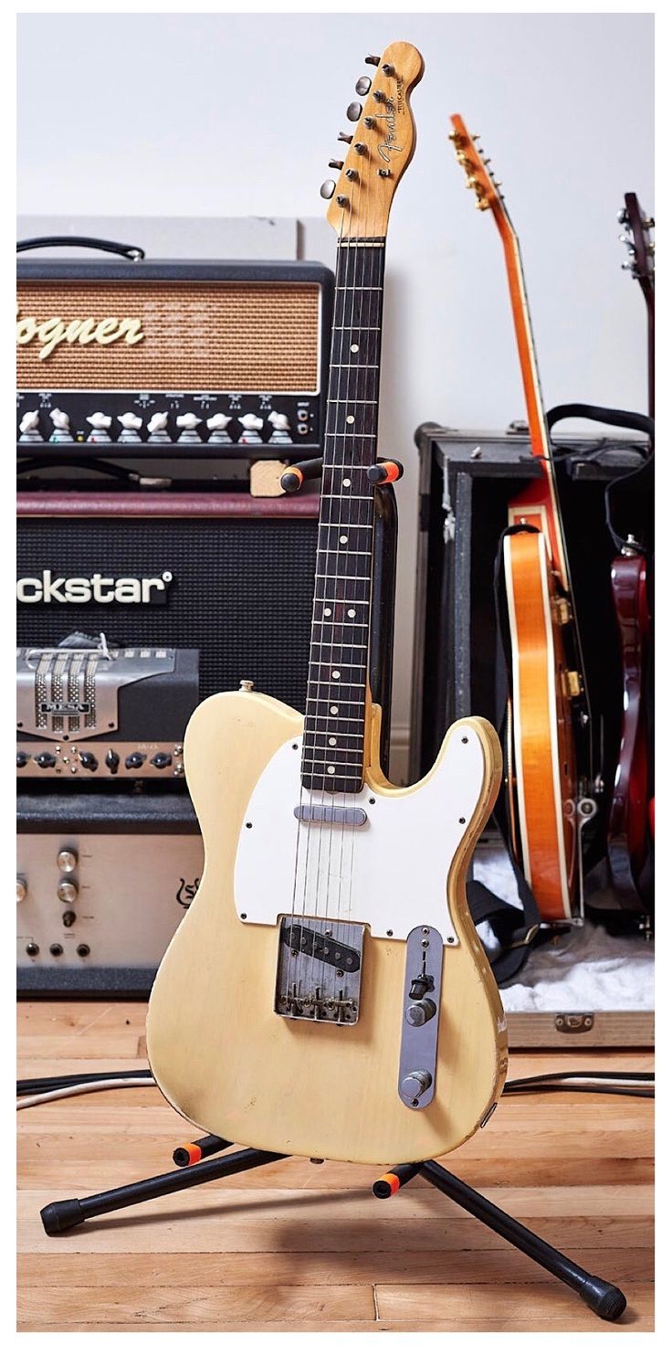 an electric guitar sitting on top of a wooden floor