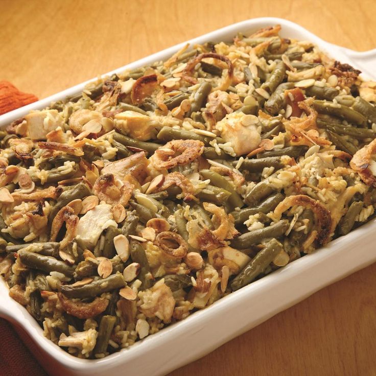 a casserole dish filled with green beans and nuts