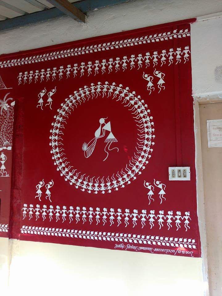 a red and white wall hanging on the side of a building