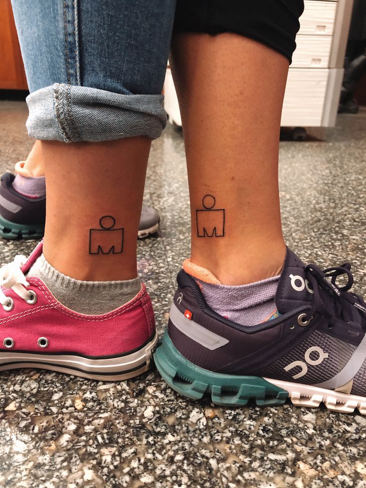 two people with matching tattoos on their feet