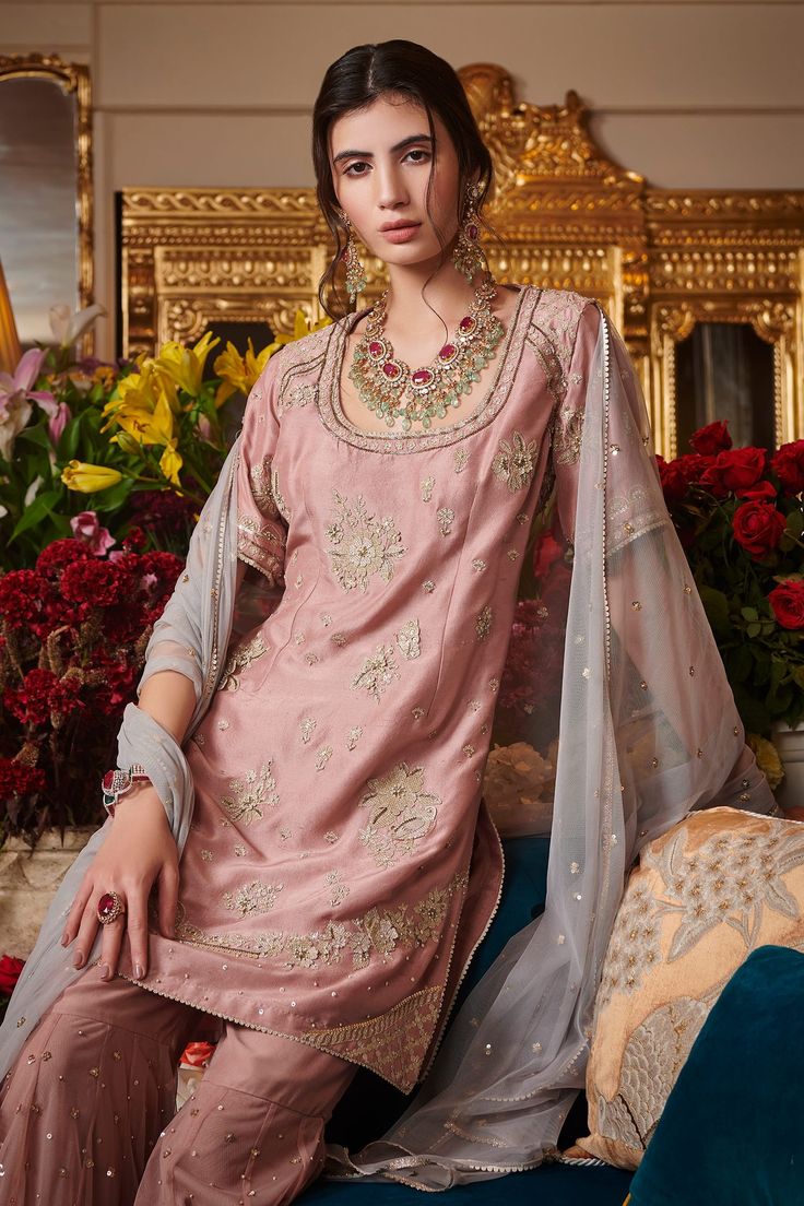 Ashrose kurta highlighted with handcrafted signature floral buttis, round neckline and straight silhouette. Comes with sharara and grey soft net dupatta. 
Component: 3
Pattern: Embroidered
Type Of Work: Floral
Neckline: Round
Sleeve Type: Half
Fabric: Organza 35GM, Soft Net, Dupion Silk
Color: Pink
Other Details: 
Straight short kurta
Embroidered sharara and dupatta
Occasion: Destination Wedding, Reception - Aza Fashions Elegant Pink Sets For Transitional Season, Elegant Semi-stitched Sharara With Gota Work, Elegant Unstitched Suit With Pallu For Reception, Elegant Unstitched Suit For Reception With Pallu, Wedding Sharara In Tissue Silk For Transitional Season, Elegant Designer Wear Sharara With Pallu, Elegant Sharara With Cutdana For Festivals, Elegant Designer Tissue Silk Sharara, Elegant Tissue Silk Sharara With Pallu Detail