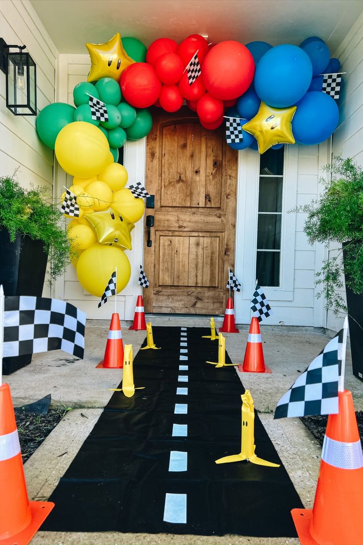 an entrance to a house decorated with balloons and checkered black and white carpeting