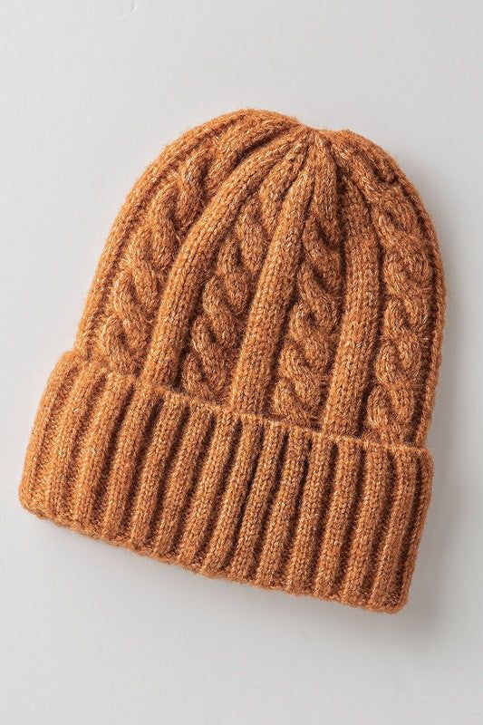 an orange knitted hat on a white surface