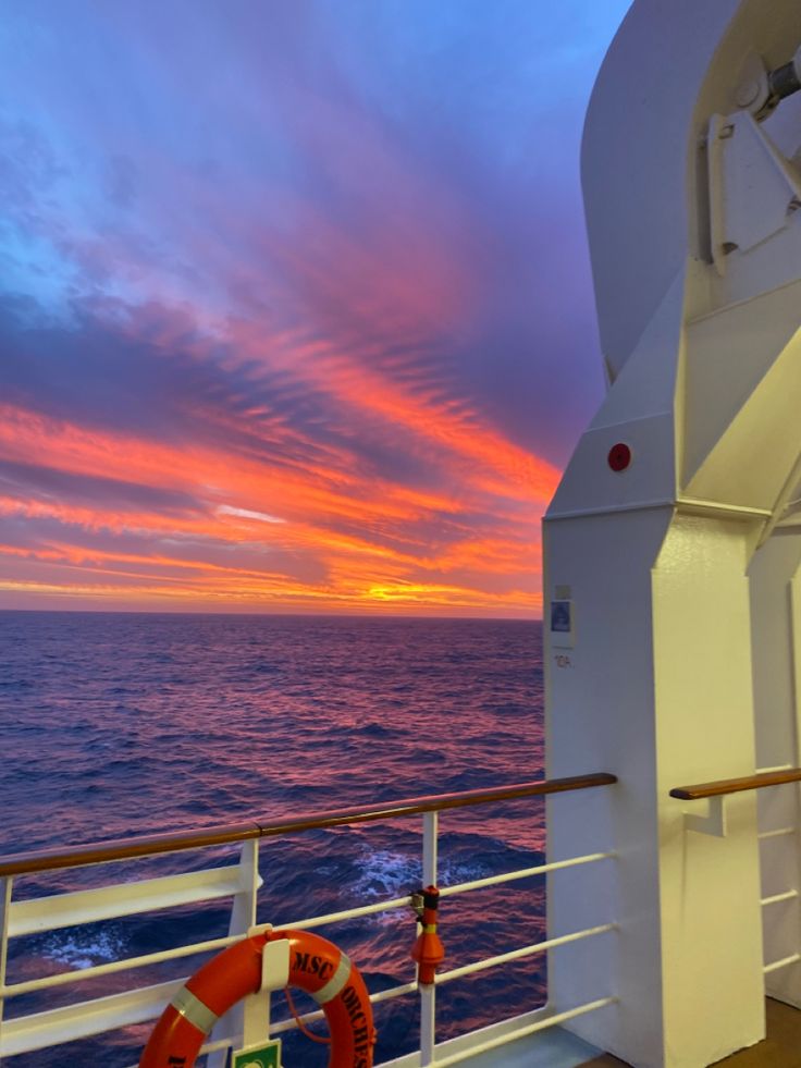 the sun is setting over the ocean on a cruise ship