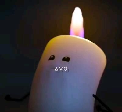 a lit candle with the word ava written on it