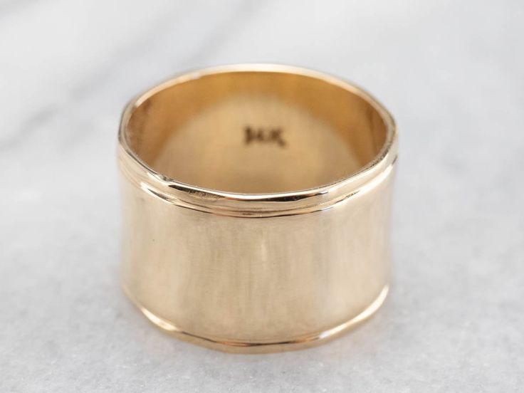 This vintage yellow gold band is absolutely stunning! Also called a cigar band, this ring has a high polish and beautiful shine. The yellow gold has a rich warmth to it that makes the ring all the more eye-catching. Metal: 14K Yellow Gold Width of Band: 12.1 mm Height off Finger: 1.0 mm Ring Size: 6.25 Marks: "14K" Stamped on the inside band Womens Wide Gold Wedding Band, Timeless 14k Gold Wide Band Ring With Open Band, Timeless 14k Gold Wide Band Ring With Open Design, Timeless Wide Band 14k Gold Open Ring, Timeless Wide Band Open Ring In 14k Gold, Fine Jewelry Yellow Gold Wide Band Ring, Yellow Gold Wide Band Ring Stamped 14k, Classic 14k Yellow Gold Wide Band Ring, Yellow Gold Signet Ring With Thick Band