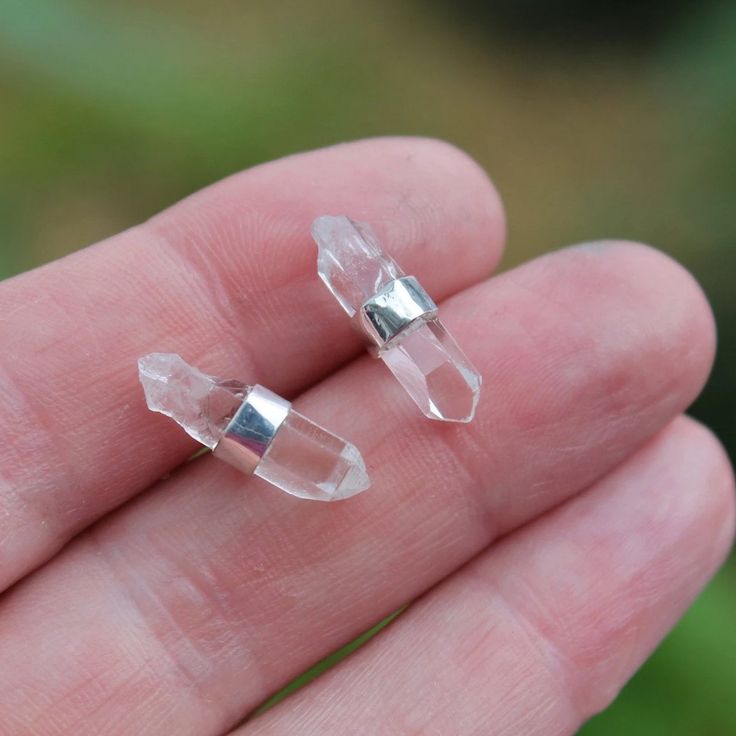 I handcraft these small quartz crystal points earrings with a sterling silver bezel wrap. Each crystal is left in it's raw natural state. The beauty and simplicity of these earrings goes along way! Each pair is unique and made just for you. Examples The first four Pictures show a pair measuring about 5/8" with a centered bezel. (5th picture shows a pair with the bezel near the top...if you would like the bezel near the top please let me know at checkout. 6th picture is showing a much shorter pai Minimalist Wire Wrapped Crystal Earrings As Gift, Minimalist Clear Crystal Earrings For Gift, Minimalist Clear Crystal Earrings Gift, Silver Quartz Jewelry Hand Wrapped, Raw Crystal, Crystal Points, Earrings Sterling Silver, Sterling Earrings, Post Earrings