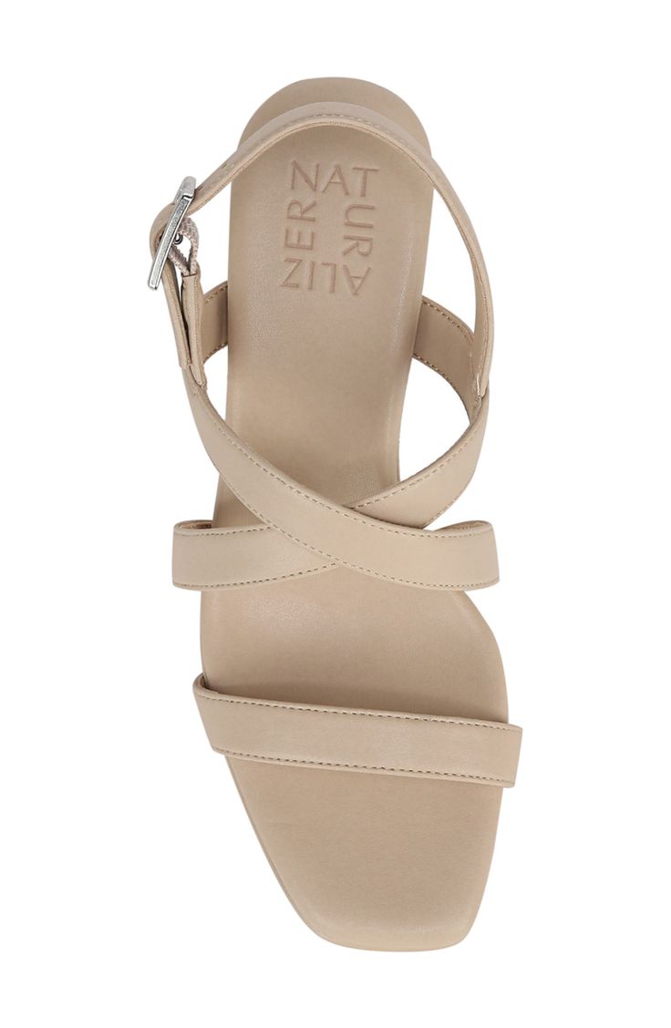 Crisscrossing straps add bold style to a comfy sandal framed by a modern square toe and tapered heel. 2 1/4" heel Cushioned insole Synthetic upper, lining and sole Imported