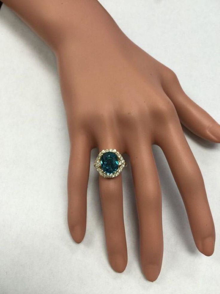 8.70 Carats Natural Very Nice Looking Blue Zircon and Diamond 14K Yellow Gold Ring Suggested Replacement Value: 9,000.00 Total Natural Cushion Shaped Zircon Weights: Approx. 7.80 Carats Zircon Measures: 11 x 8.4mm Natural Round Diamonds Weight: .90 Carats (color G-H / Clarity SI1-SI2) Ring total weight: 5.2 grams Disclaimer: all weights, measurements and colors are approximate and may vary slightly from the listed dimensions or as seen in the image. All pictures are magnified to show the smalles Luxury Blue Sapphire Ring With 17 Jewels, Luxury Blue Diamond Ring With Accents, Elegant Blue Emerald Ring With Prong Setting, Formal Topaz Crystal Ring, Elegant Blue Emerald Ring With Brilliant Cut, Luxury Blue Emerald Ring For Wedding, Formal Sapphire Crystal Ring, Luxury Blue Emerald Wedding Ring, Blue Emerald Ring With Brilliant Cut