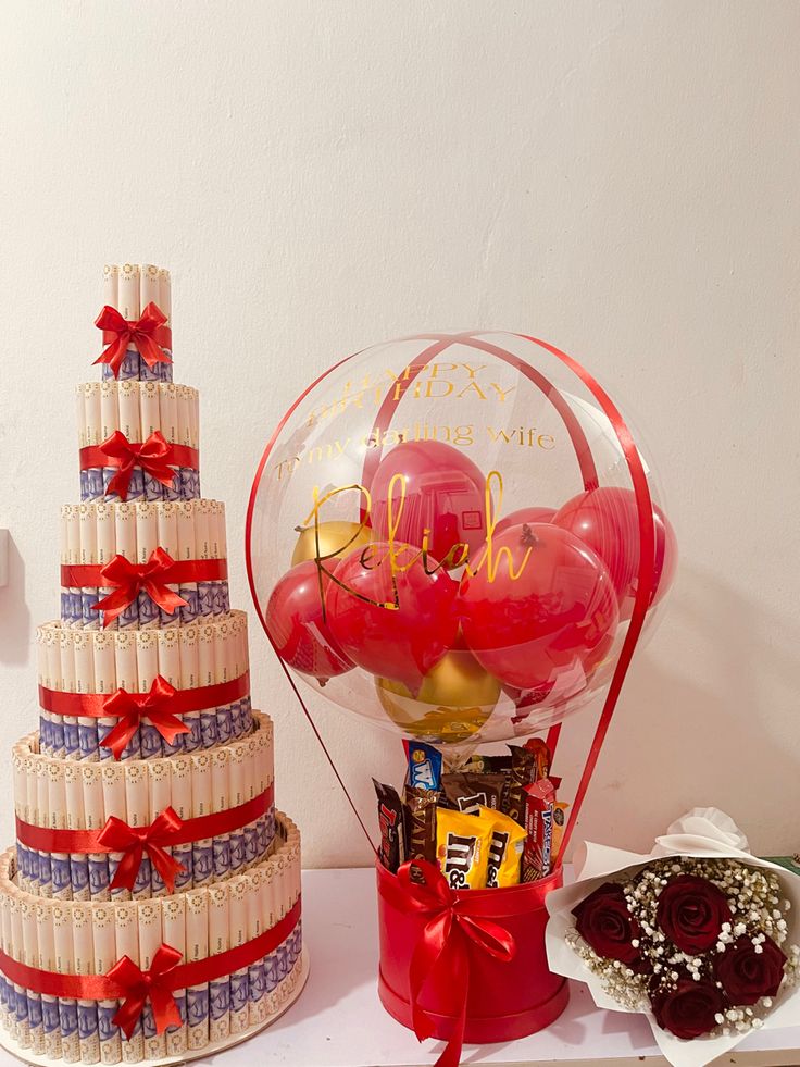 a three tiered wedding cake next to a large balloon