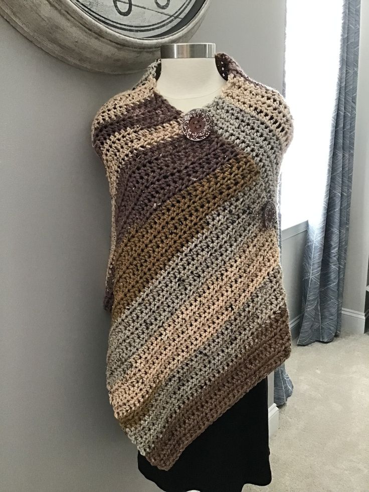 This hand crocheted poncho features rustic colors of brown, gold, tan, peach. It's made with a chunky ever so soft high quality chunky yarn. One size fits most. Machine wash cold water, gentle cycle, dry flat. The front has large wooden buttons in a pumpkin color going down it diagonally as embellishmentonly, not functional buttons. Handmade Brown Bohemian Poncho, Beige Crochet Poncho For Fall, Fall Crochet Beige Poncho, Handmade Beige Poncho One Size, Handmade Brown Shawl Poncho, Hand Knitted Beige Poncho For Fall, Hand Knitted Brown Poncho For Fall, Hand-knitted Brown Poncho For Fall, Ladies Poncho