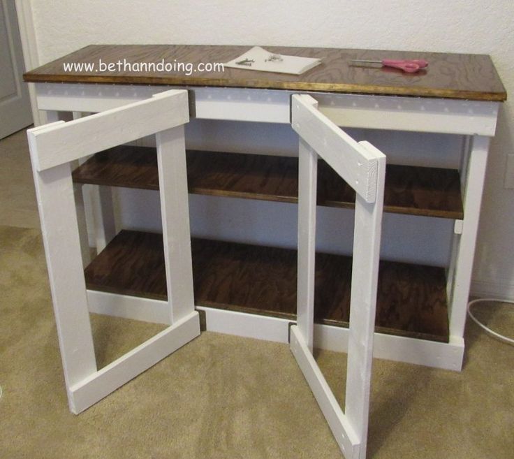 a white desk with two open shelves on top