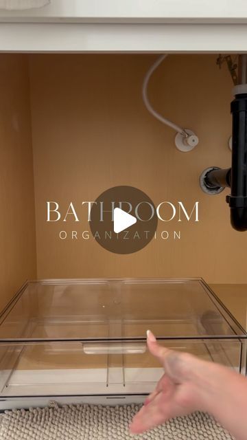 a person pointing at the bottom of a bathtub with an organation logo on it