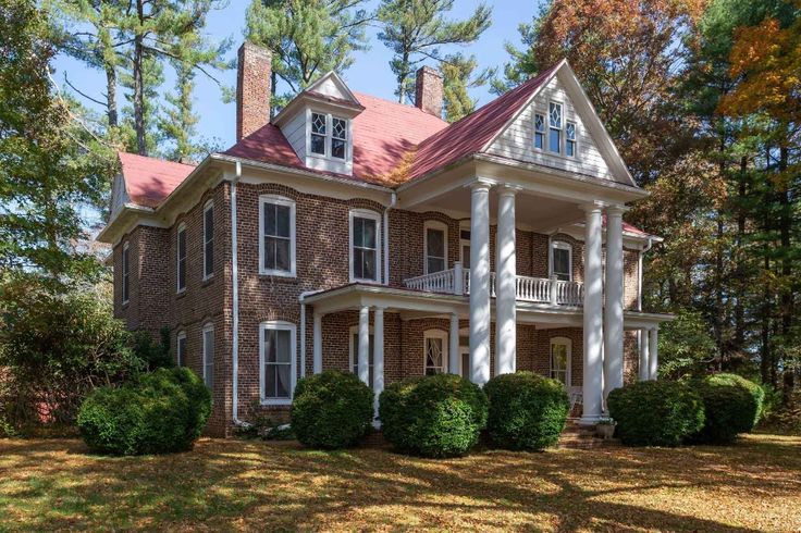 a large brick house surrounded by trees