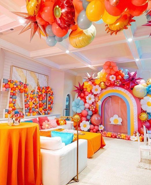 a room filled with lots of balloons and decorations