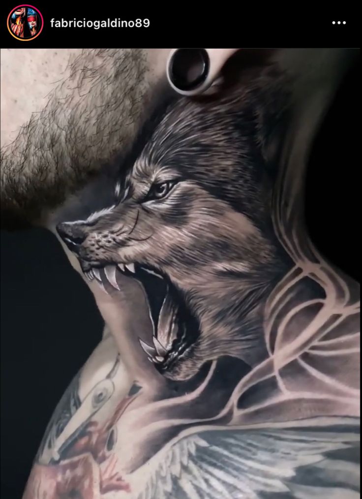 a man's chest with an angry wolf tattoo on it