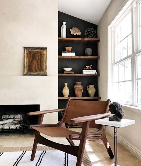 a living room filled with furniture and a fire place in front of a large window