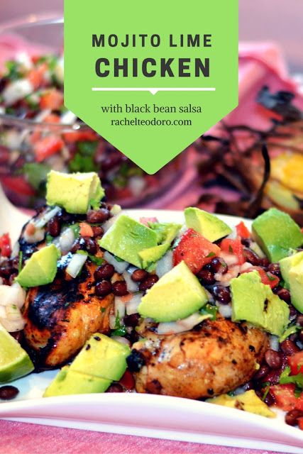 chicken with black beans, avocado and salsa on a white plate in front of a pink table cloth