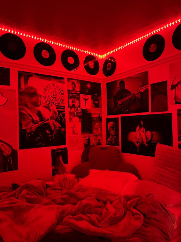 a bedroom with red lights and pictures on the wall