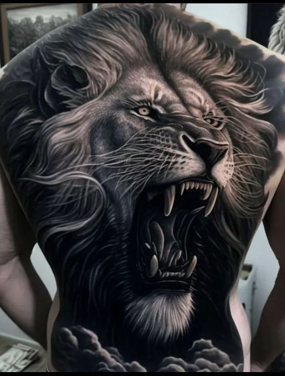 a man with a lion tattoo on his back