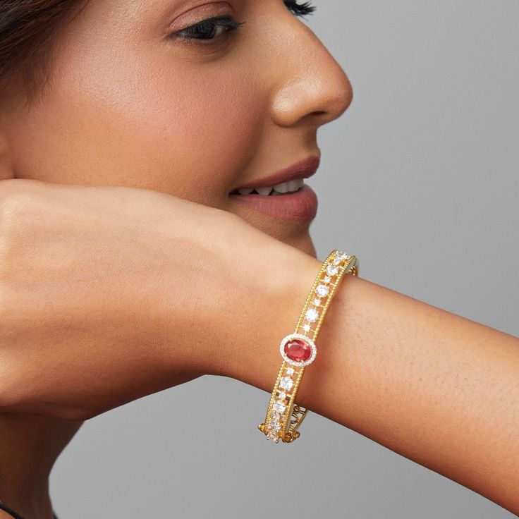 Description: The Neelima CZ bracelet features a stunning combination of red and white stones on a gold-plated base. it's simple yet elegant design makes it a versatile piece that can be worn for any occasion, from casual outings to formal events. The bracelet’s timeless appeal ensures it will be a cherished addition to any jewelry collection. Details & Specification: Materials used: Brass Alloy with Gold & White Gold Platting Weight - 17.5 gm Length - 6 cm Make it custom: Want to make it a custo Red Ruby Bracelet For Festive Occasions, Festive Red Ruby Bracelet, Red Gemstone Bracelet For Wedding, Red Ruby Bangle For Festive Occasions, Red Ruby Gemstone Bangle, Red Ruby Temple Jewelry Bangle, Red Bracelet, Cz Bracelet, White Stones