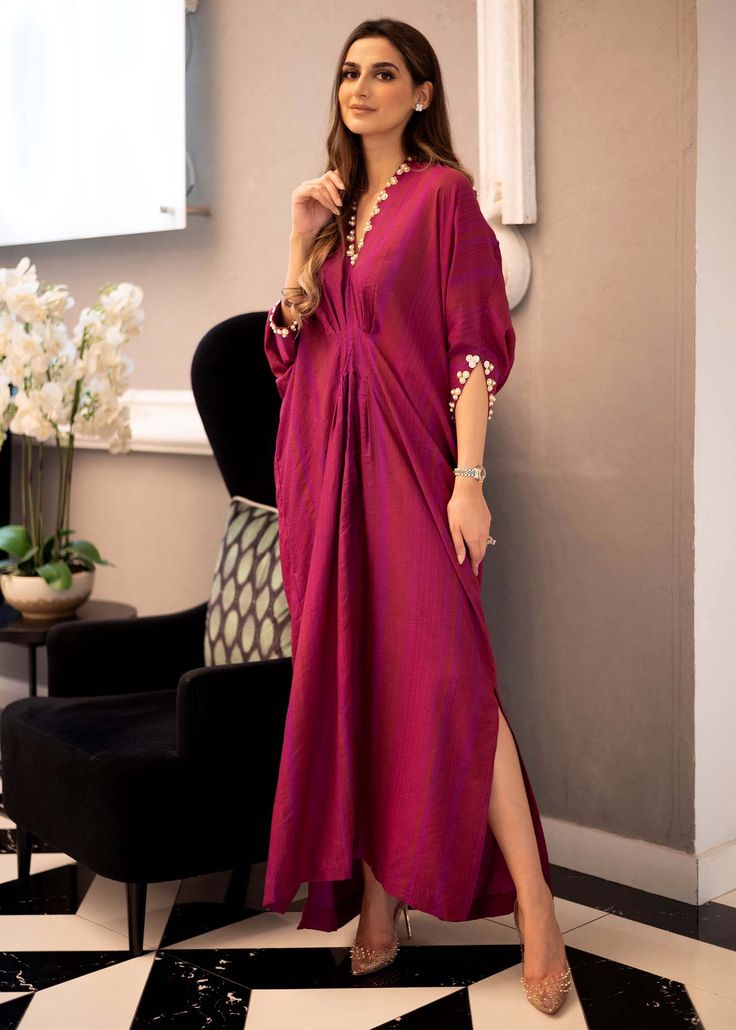 Easy breezy Magenta Kaftan in cotton silk fabric with handwork details on the neckline, sleeves and shoulder slits Cotton Party Dresses For Eid, Elegant Cotton Silk Straight Kurta Dress, Silk Kurta With Embroidered Neckline And Long Sleeves, Elegant Cotton Silk Dress For Designer Wear, V-neck Kurta With Dabka Work For Party, Elegant Cotton Silk Dresses For Eid, Elegant Floor-length Summer Kurta, Elegant Cotton Dresses For Eid, Designer Eid Dress With V-neck