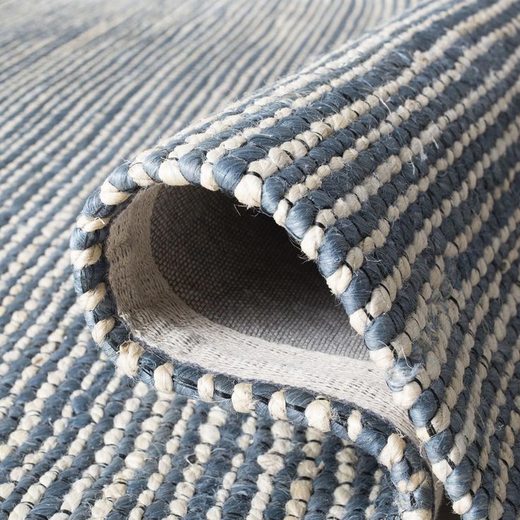 a close up view of a blue and white rug with an opening in the middle