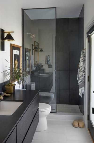 a bathroom with a sink, mirror and toilet in it's own area next to a walk - in shower