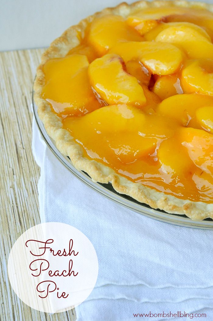 a fresh peach pie is sitting on a table